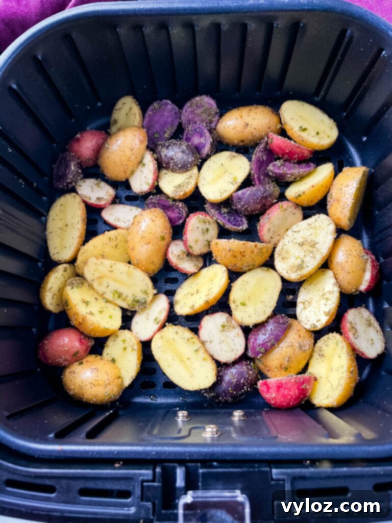 Crispy Ranch Roasted Potatoes 7 Seasoned raw sliced potatoes arranged neatly in an air fryer basket