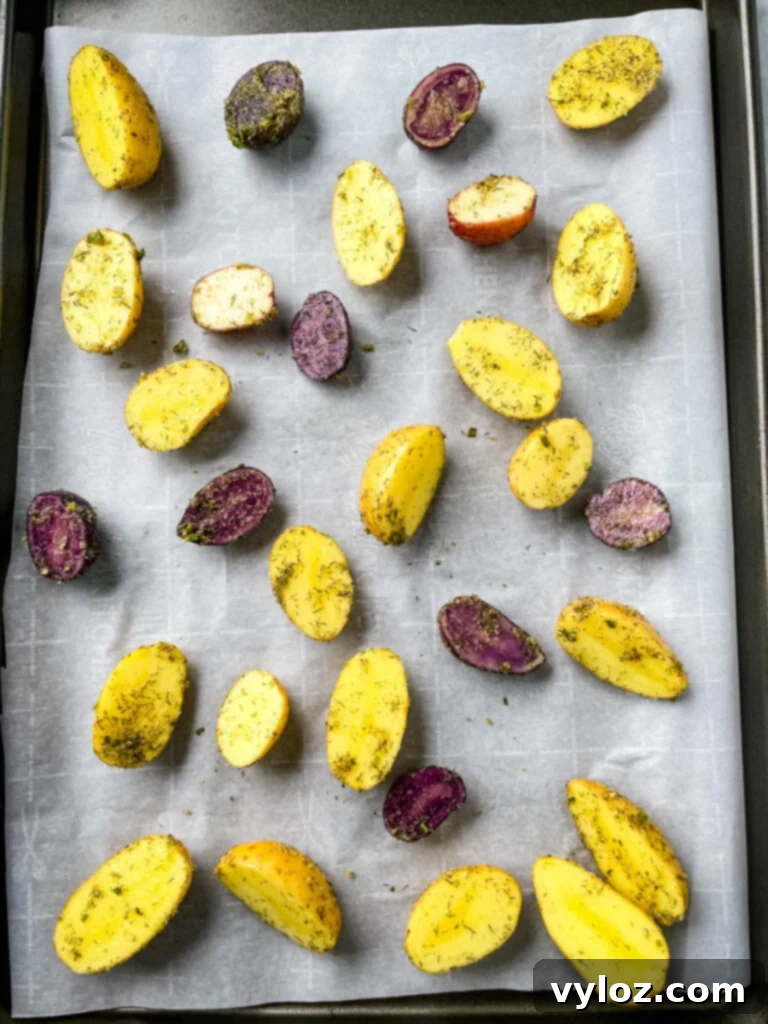 Crispy Ranch Roasted Potatoes 8 Seasoned raw potatoes spread on a sheet pan, prepared for oven baking