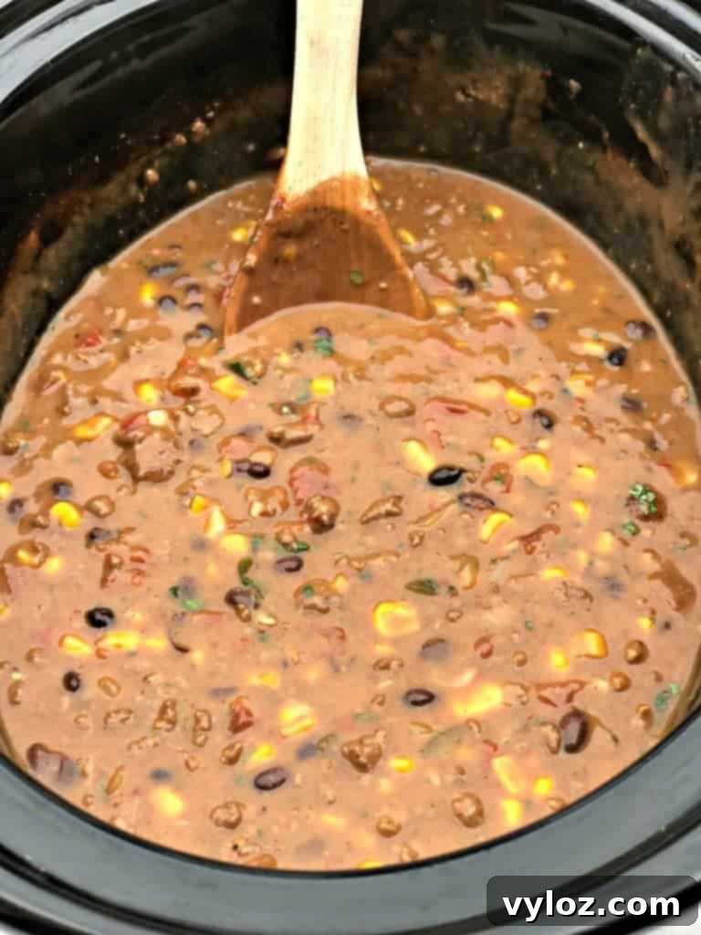 Slow Cooker Beef Fiesta Chili 4 Ingredients for Slow-Cooker Beef Taco Nacho Chili simmering in a slow cooker