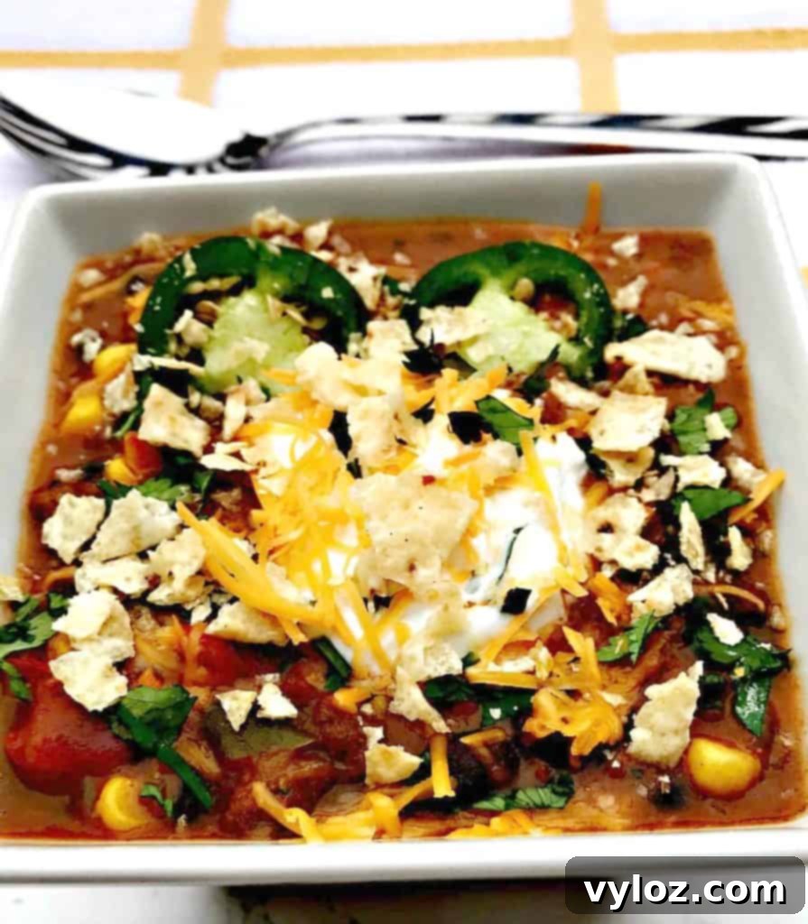 Slow Cooker Beef Fiesta Chili 8 Bowl of Slow-Cooker Beef Taco Nacho Chili with a variety of fresh toppings