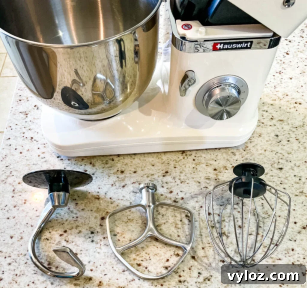 Hauswirt stand mixer with stainless steel bowl and attachments on a kitchen counter, ready for use