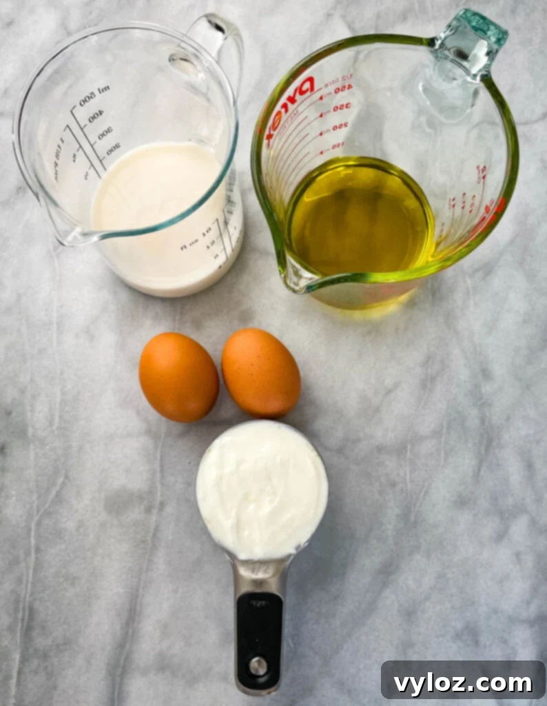 Simple Cinnamon Streusel Coffee Cake Muffins 3 milk, olive oil, eggs, and Greek yogurt in separate bowls