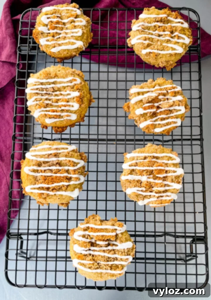 Simple Cinnamon Streusel Coffee Cake Muffins 9 coffee cake muffins with icing on a cooling rack