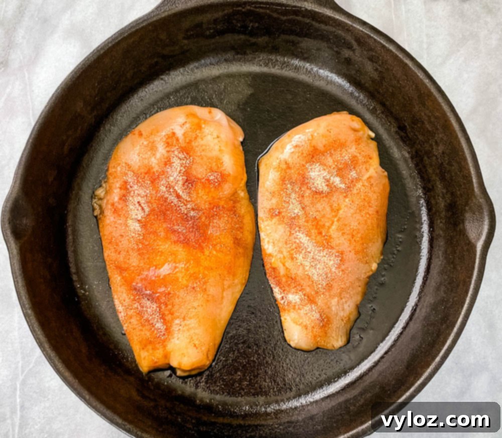 Vibrant Chicken Avocado Salsa 7 raw chicken breasts in a cast iron skillet