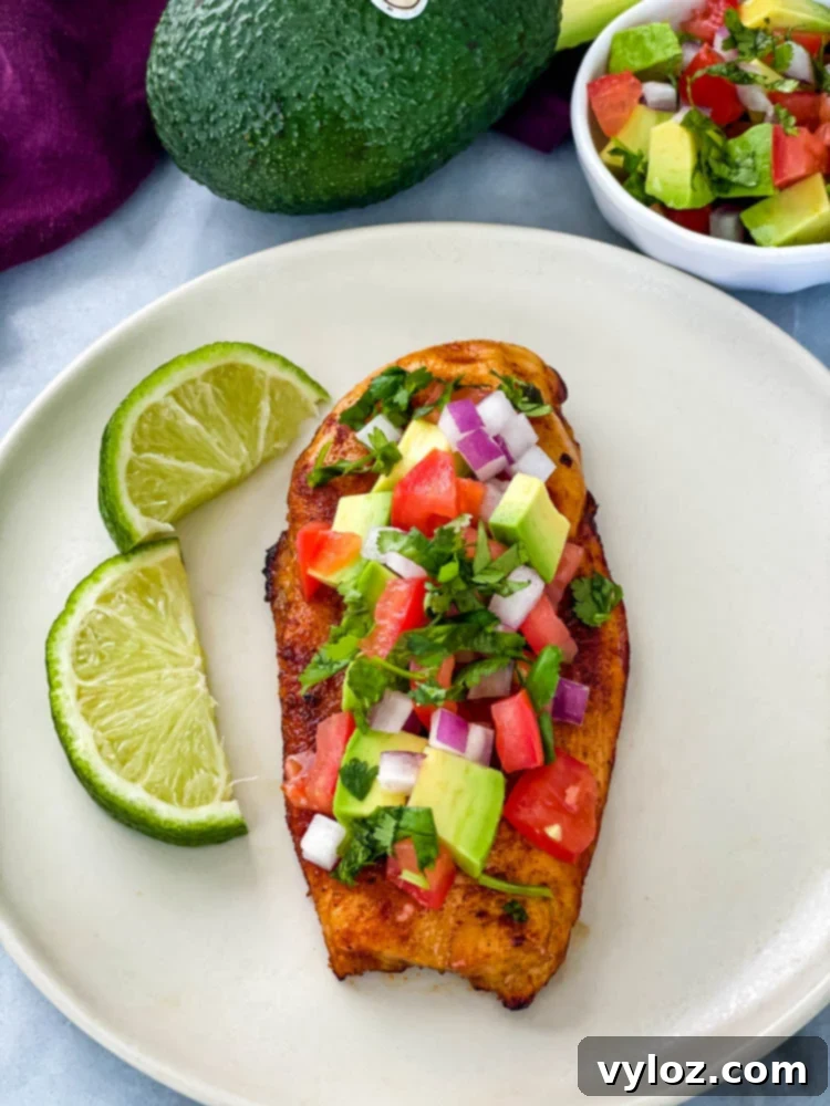 Vibrant Chicken Avocado Salsa 9 cooked chicken and avocado salsa on a plate with limes