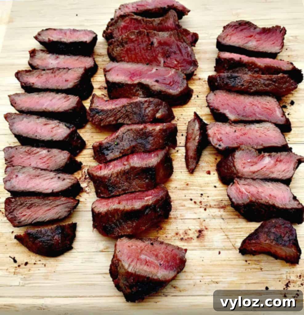 One-Pan Steak and Veggies Meal Prep 3 Close-up of marinated steak and mixed vegetables on a sheet pan