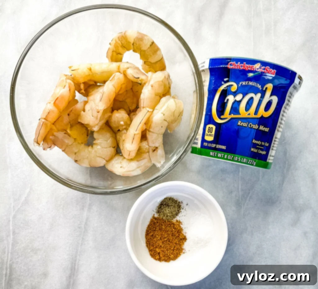 Raw lump crab meat and raw shrimp in separate bowls, ready for cooking.
