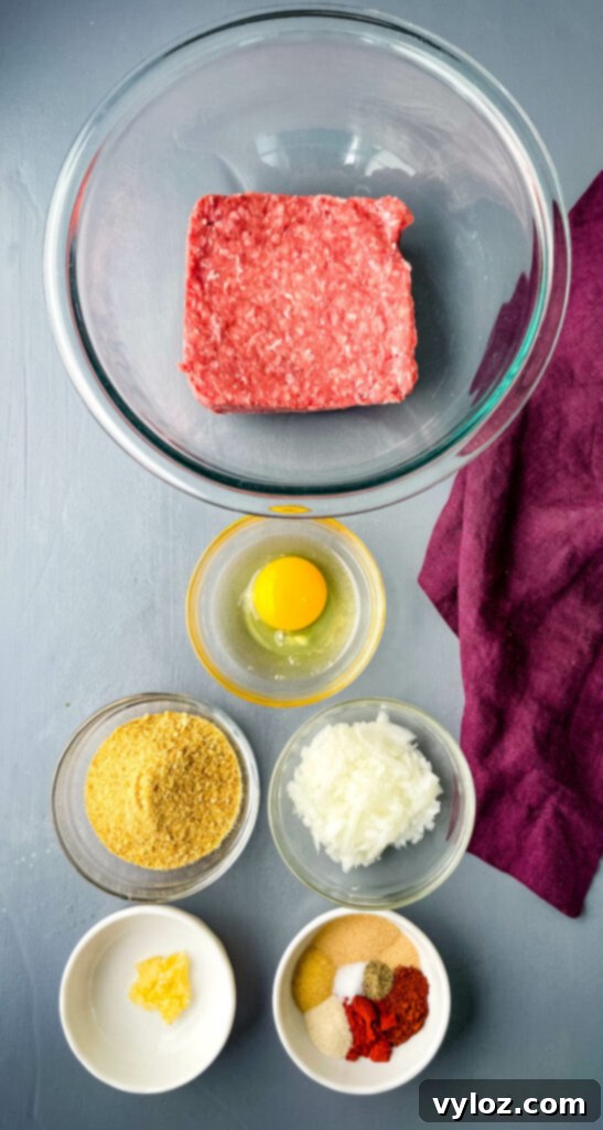 Set-It-and-Forget-It BBQ Meatballs 3 Raw ground beef, raw egg, breadcrumbs, chopped onions, garlic, and BBQ rub in separate bowls, ready for mixing