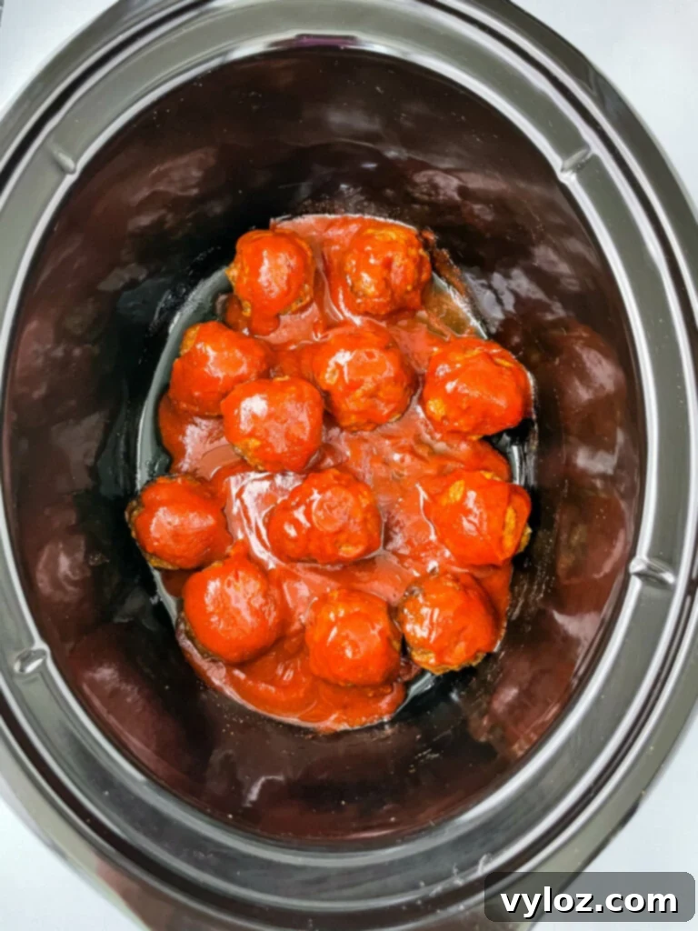Set-It-and-Forget-It BBQ Meatballs 9 Cooked BBQ meatballs in a slow cooker, glistening with sauce