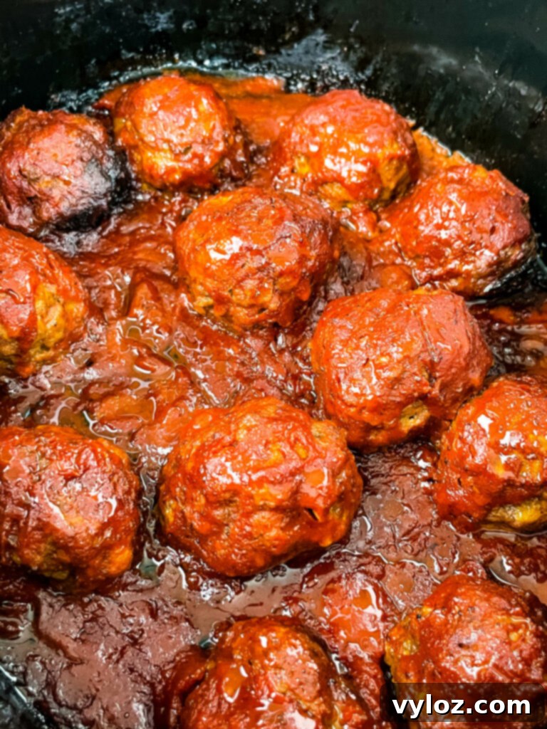 Set-It-and-Forget-It BBQ Meatballs 10 BBQ meatballs in a slow cooker, ready for serving