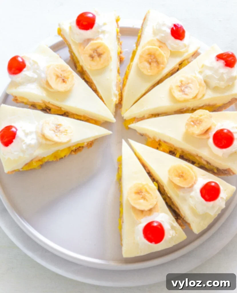 A slice of banana split pie on a plate, garnished with whipped cream and a cherry, showing off its creamy layers.
