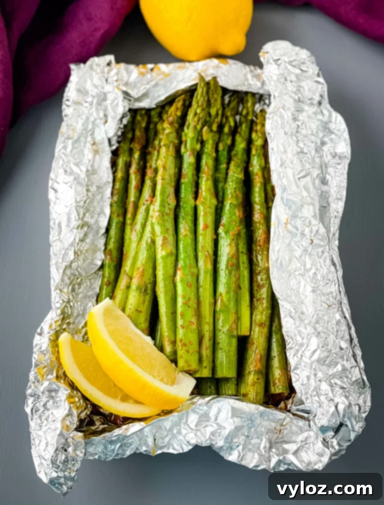 Grilled Asparagus Foil Packets 7 Cooked grilled asparagus in a foil packet, ready to be served