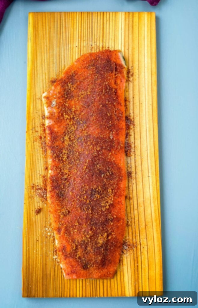 raw salmon on a cedar plank with spices