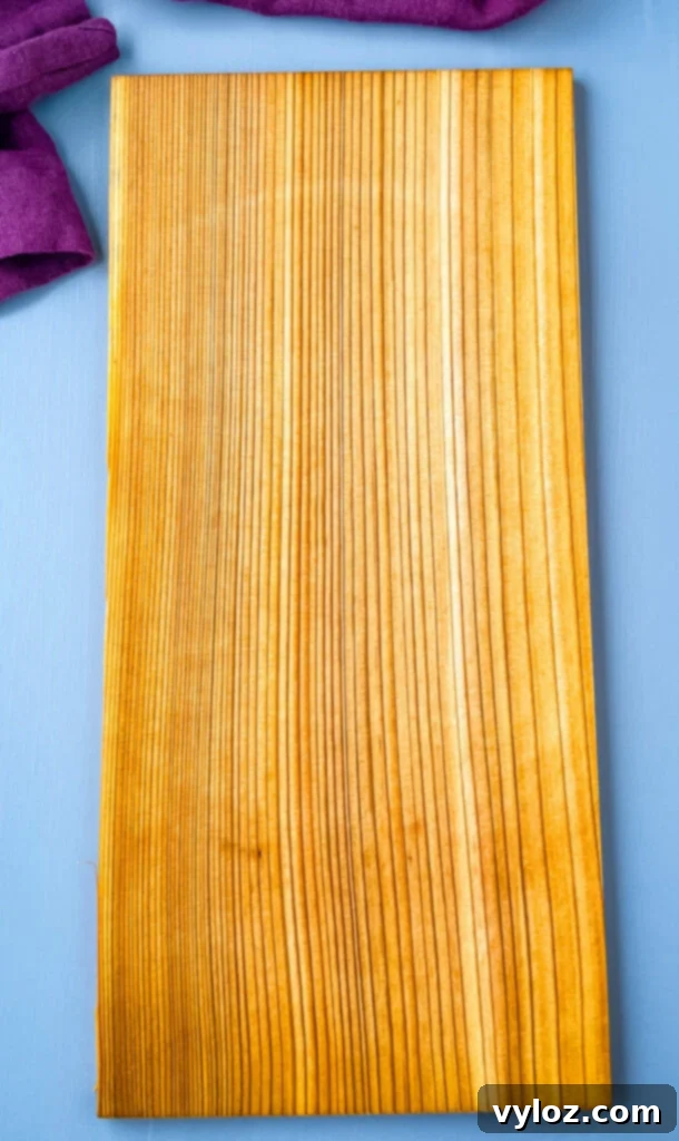 A pristine cedar plank resting on a clean kitchen surface, ready for soaking and grilling.