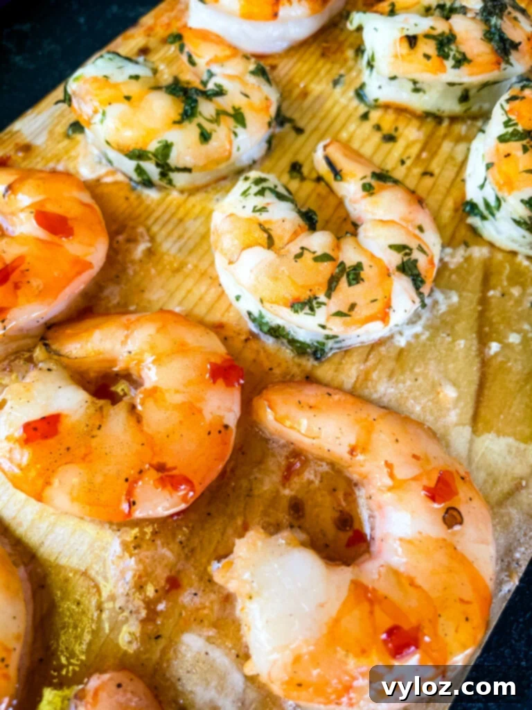 Deliciously cooked grilled shrimp presented on a cedar plank, ready for enjoyment.