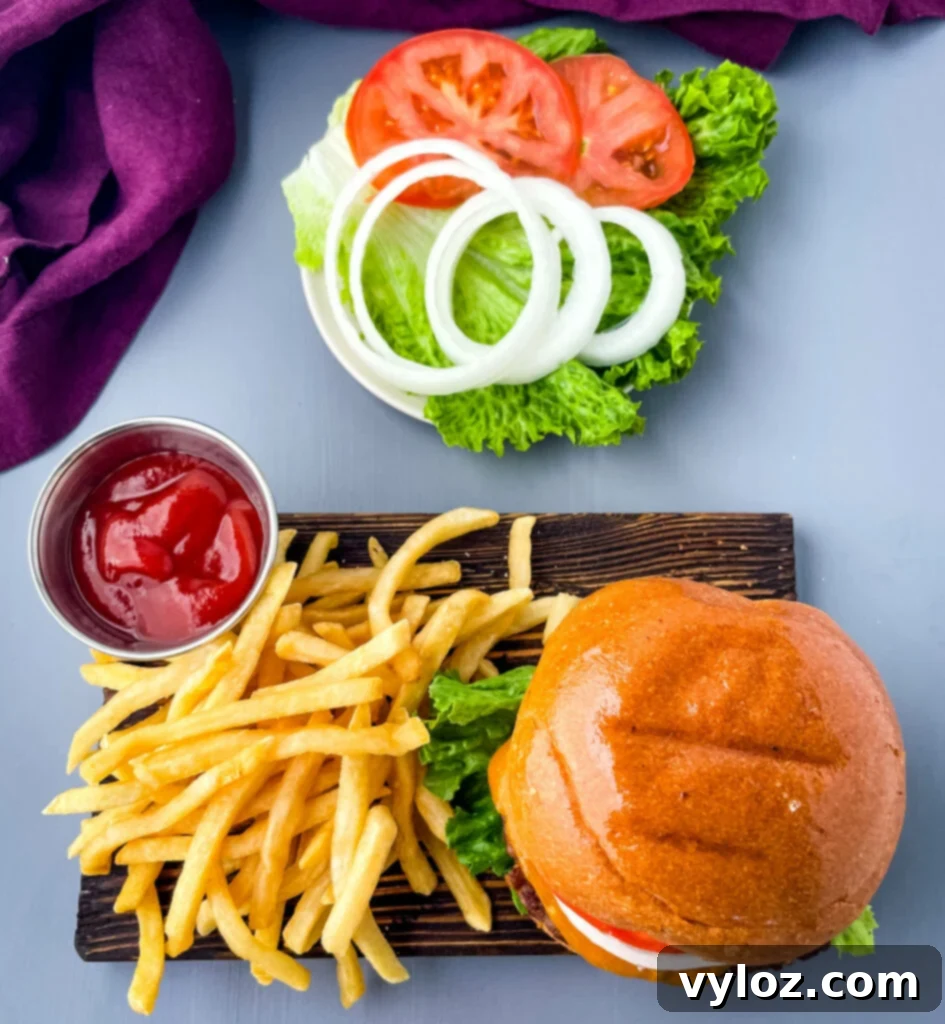 Achieve Burger Perfection on Any Grill 11 A well-composed shot of a grilled burger, possibly with melted cheese, on a bun