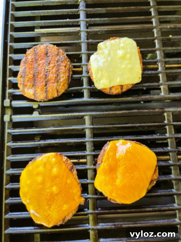 Achieve Burger Perfection on Any Grill 6 Cooked hamburgers on a grill with cheese melting on top