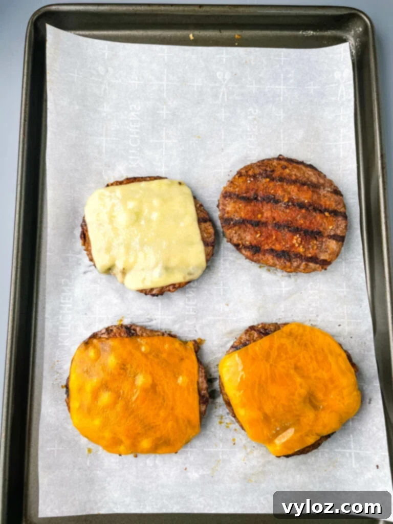 Achieve Burger Perfection on Any Grill 7 Cooked cheeseburgers on a sheet pan, ready to be assembled
