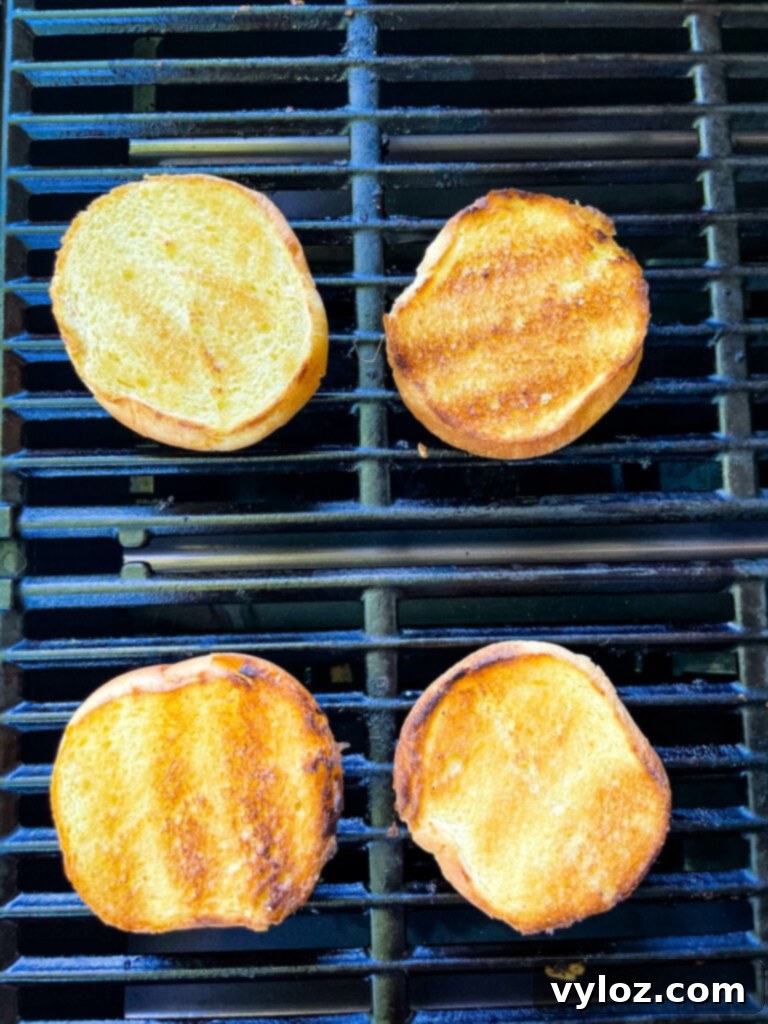 Achieve Burger Perfection on Any Grill 9 Toasted brioche buns on a grill, perfectly golden