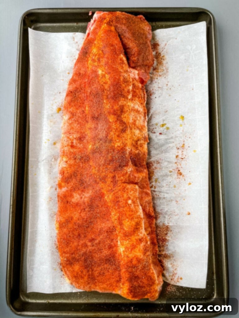 Raw seasoned baby back ribs ready for the grill