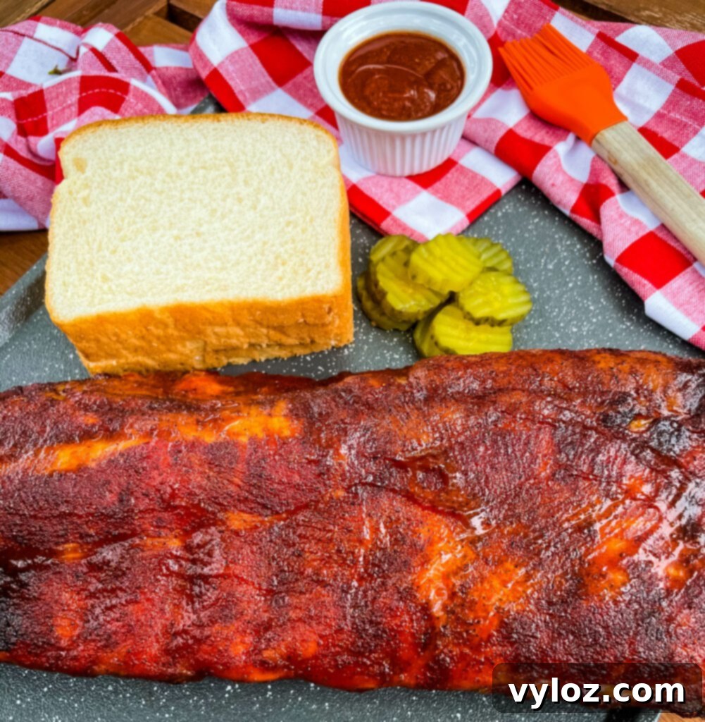 Platter of grilled baby back ribs with sides