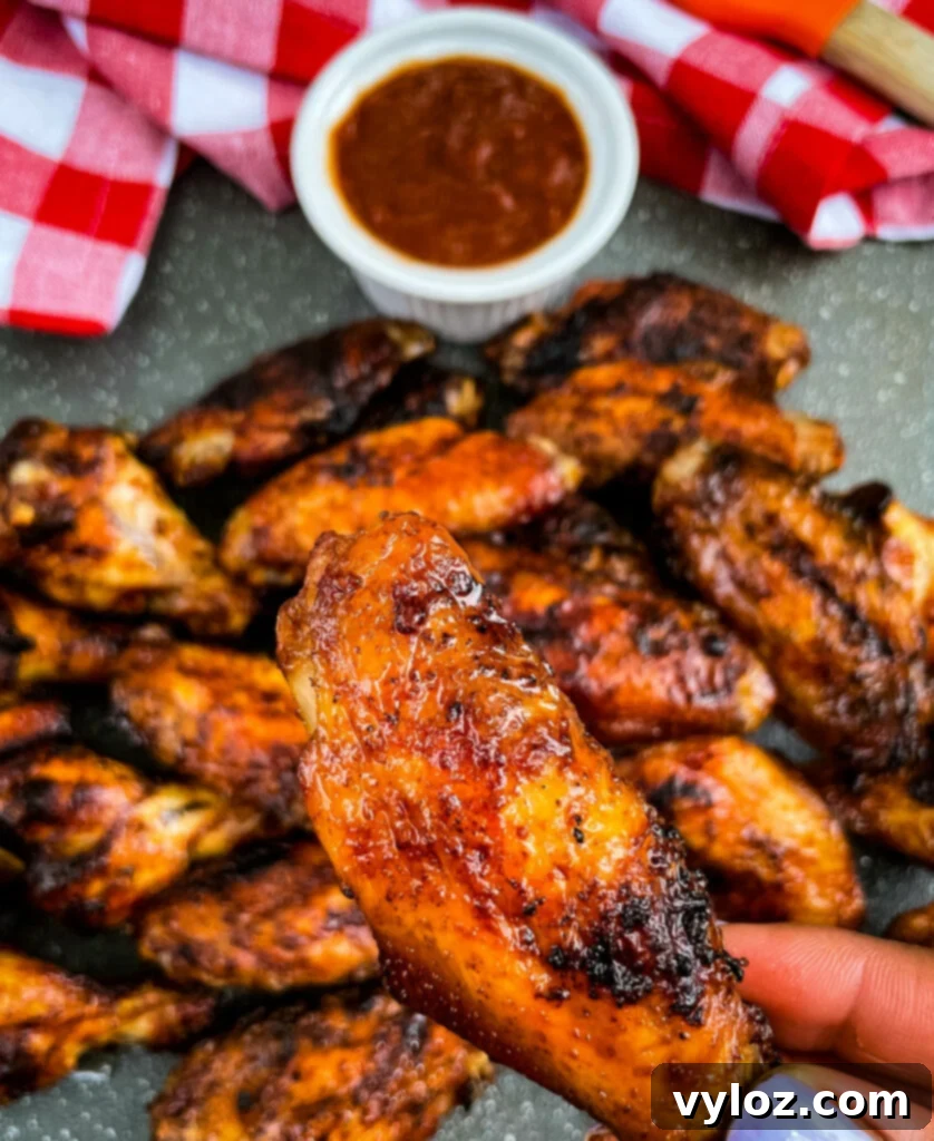 Perfect Grilled Chicken Wings 13 A vibrant plate of grilled chicken wings with a variety of dipping sauces