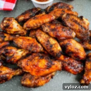 Perfect Grilled Chicken Wings 14 Grilled chicken wings on a plate with BBQ sauce