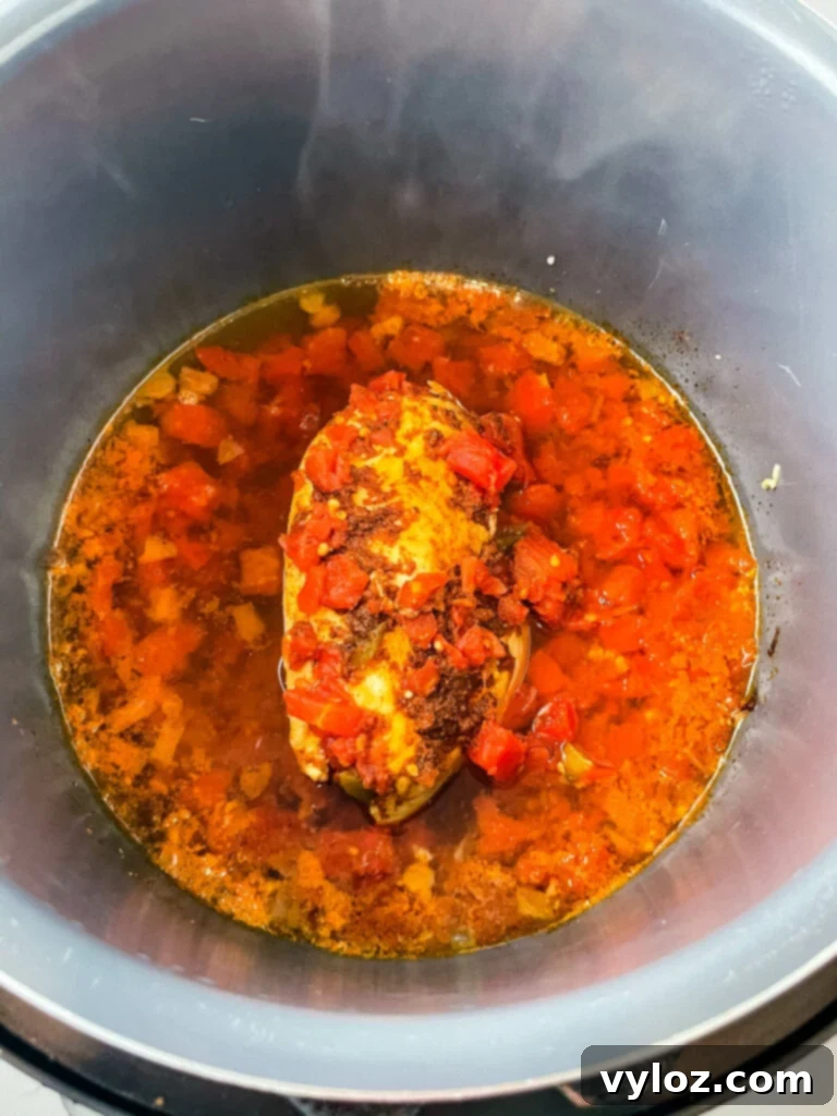 chicken breast in an Instant Pot with diced tomatoes and chilies