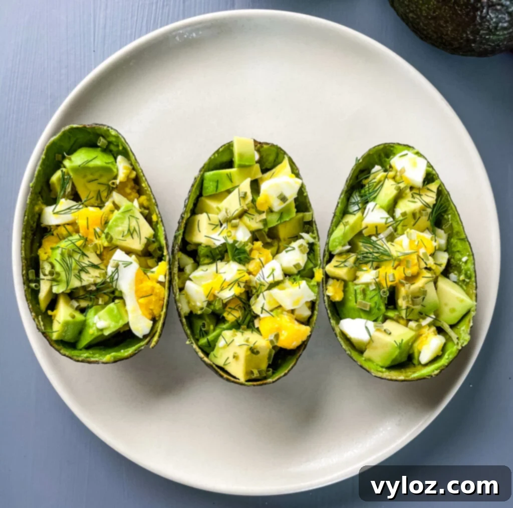 Savory Avocado Egg Bites 2 Delicious Avocado Egg Salad Cups presented beautifully on a plate, ready to be enjoyed.