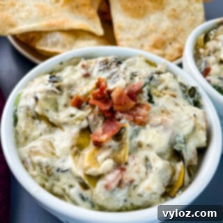 bacon spinach artichoke dip in separate bowls with chips