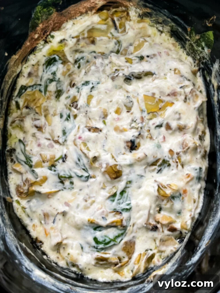 bacon spinach artichoke dip in a slow cooker