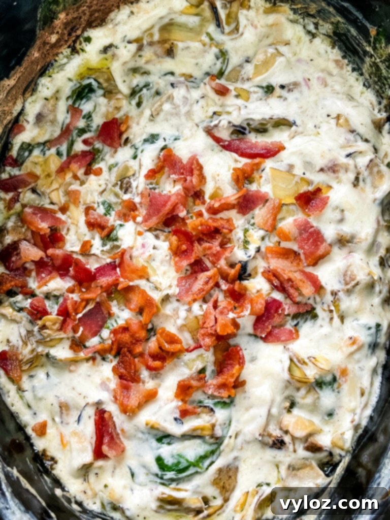 bacon spinach artichoke dip in a slow cooker