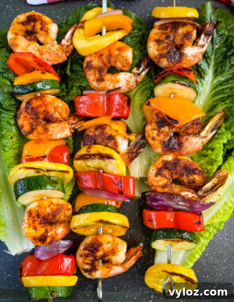 No Fuss Grilled Shrimp Skewers 2 BBQ grilled shrimp skewers on a bed of lettuce
