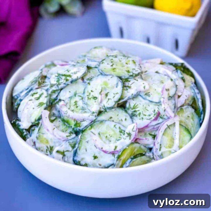 Refreshing Creamy Cucumber Salad with thinly sliced cucumbers and onions, coated in a rich, mayo-based dressing.