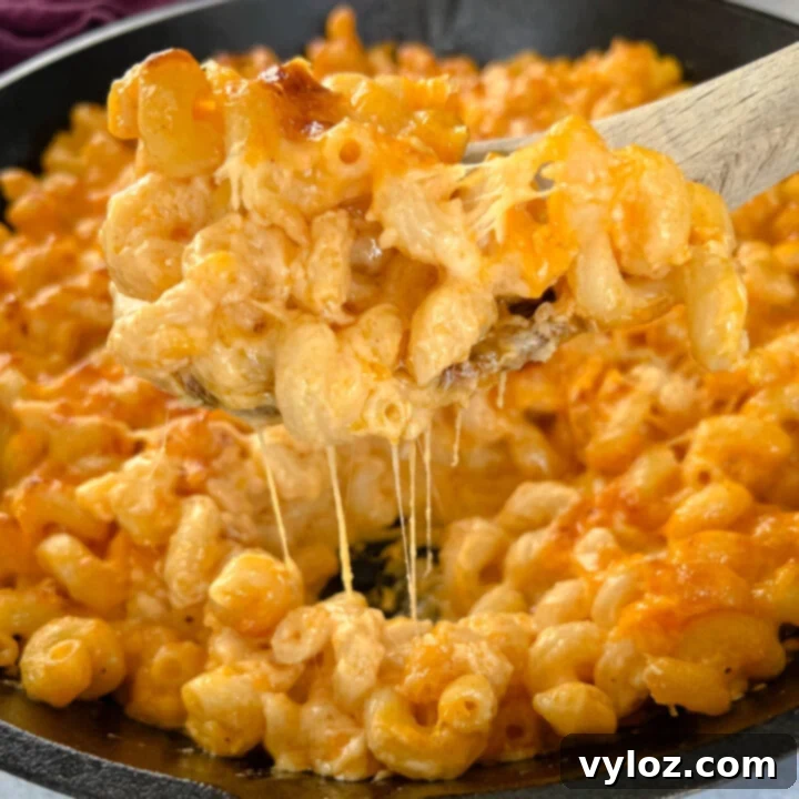 A dish of rich, incredibly creamy Smoked Mac and Cheese with a beautifully golden-brown, crispy topping, fresh out of the smoker.