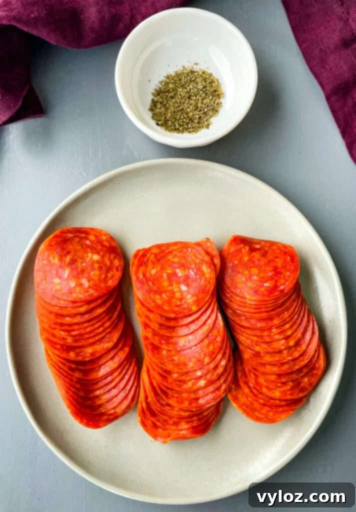 pepperoni on a plate with Italian Seasoning