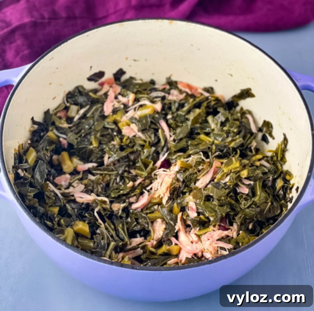 Vibrant Southern collard greens simmering in a purple pot, ready to serve.