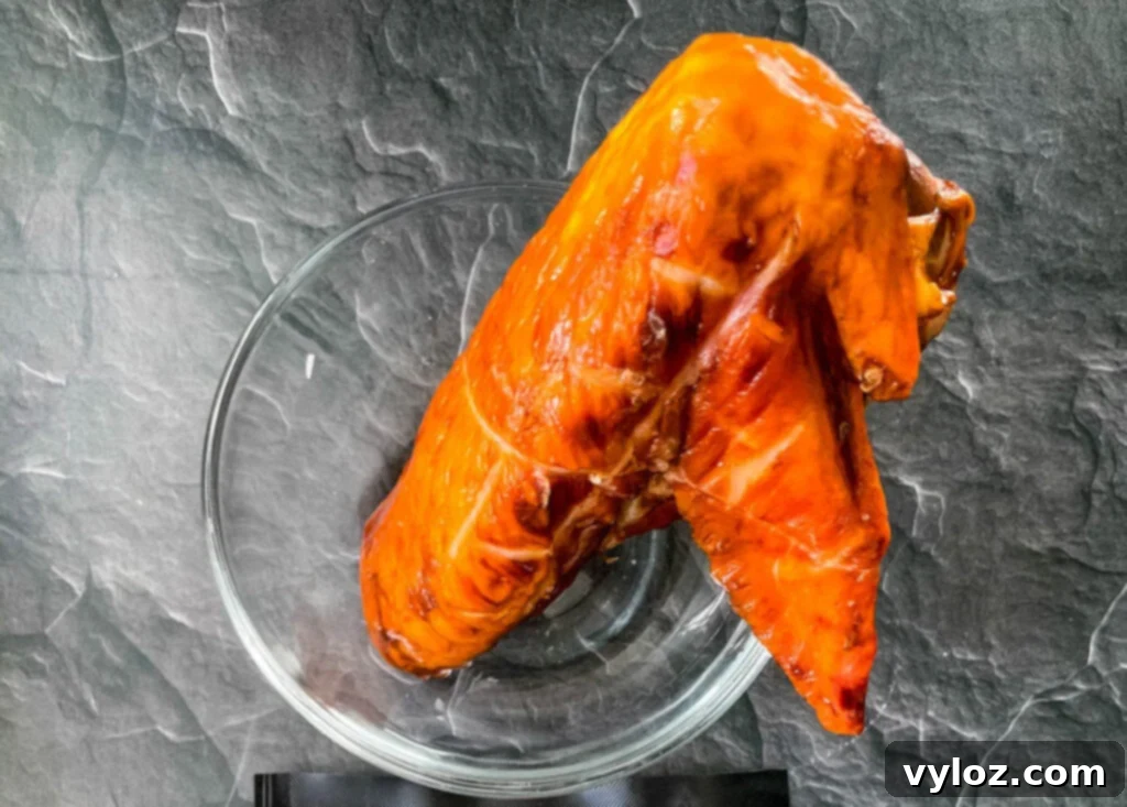 Hands demonstrating how to remove stems from collard greens.