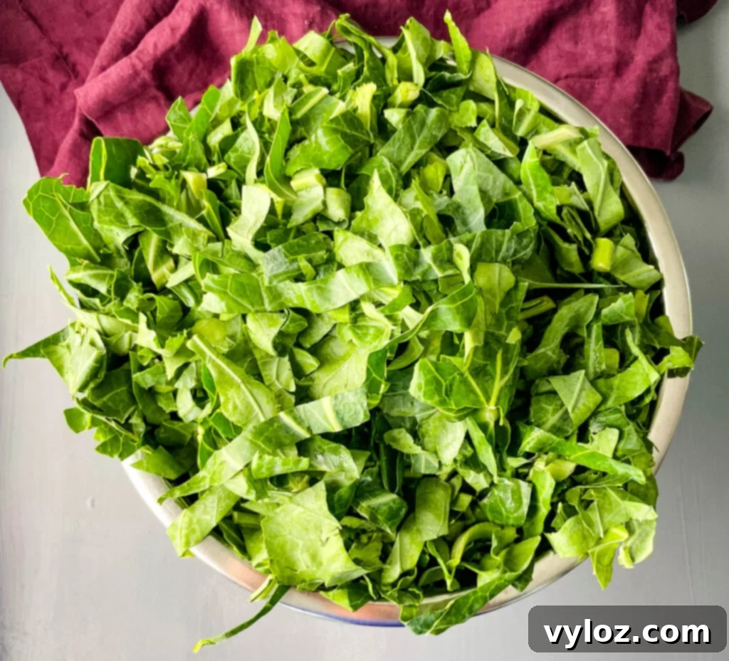 Clean collard greens soaking in a large bowl of water.