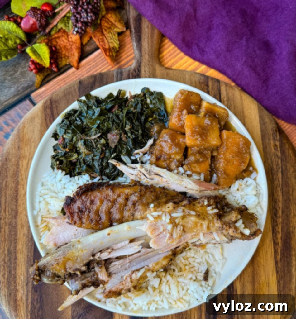 Succulent Roasted Turkey Wings 16 baked turkey wings falling off the bone on a plate with collard greens, sweet potatoes, and white rice