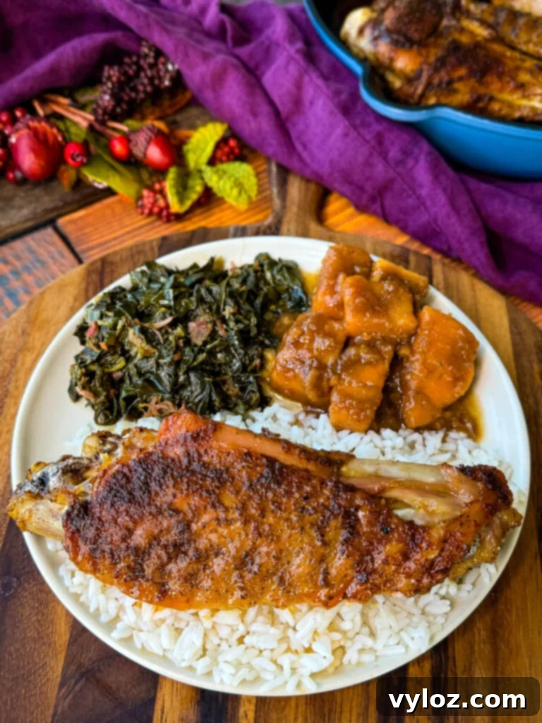 Succulent Roasted Turkey Wings 10 baked turkey wings on a plate with collard greens, sweet potatoes, and white rice