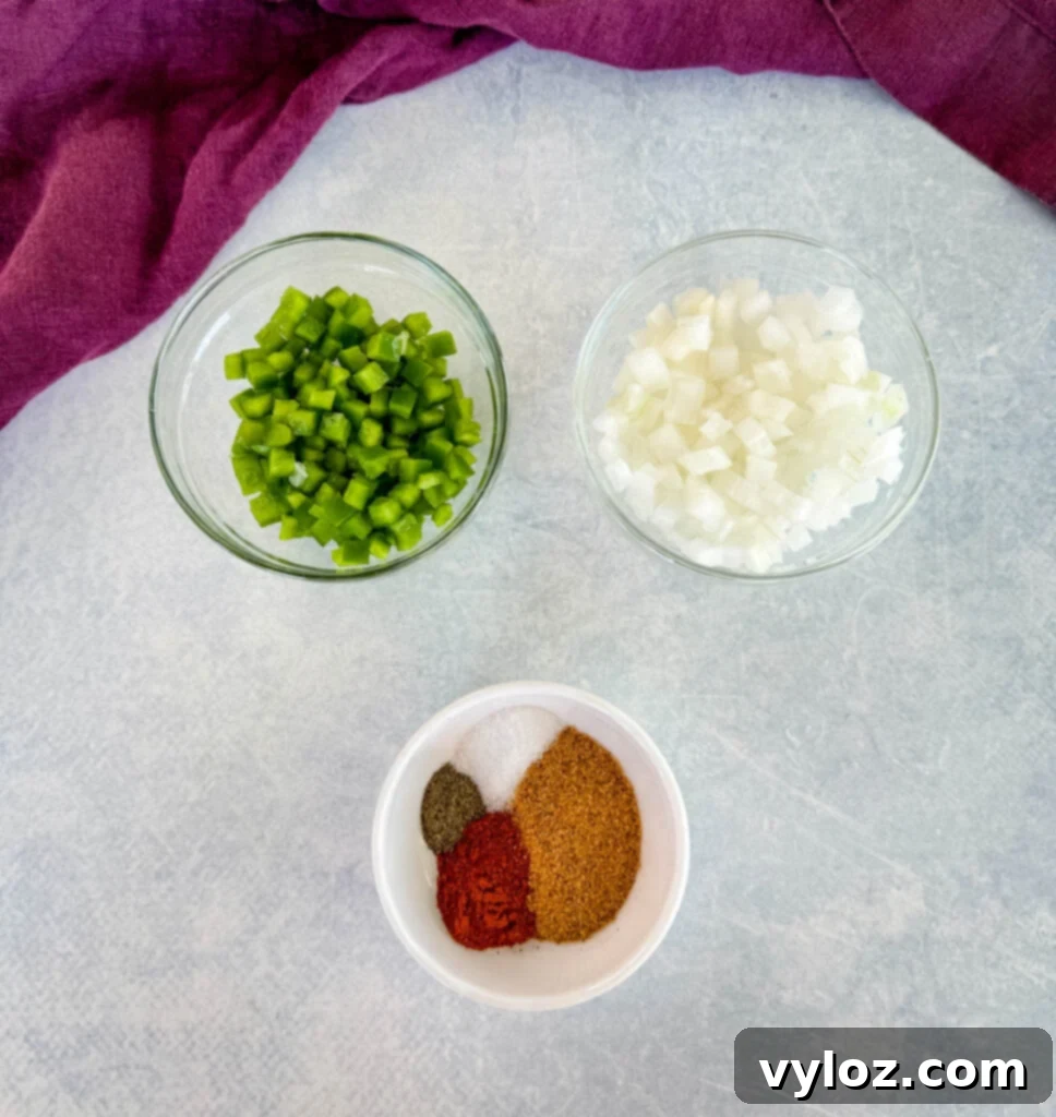 Diced onions, diced bell peppers, and various spices in separate bowls