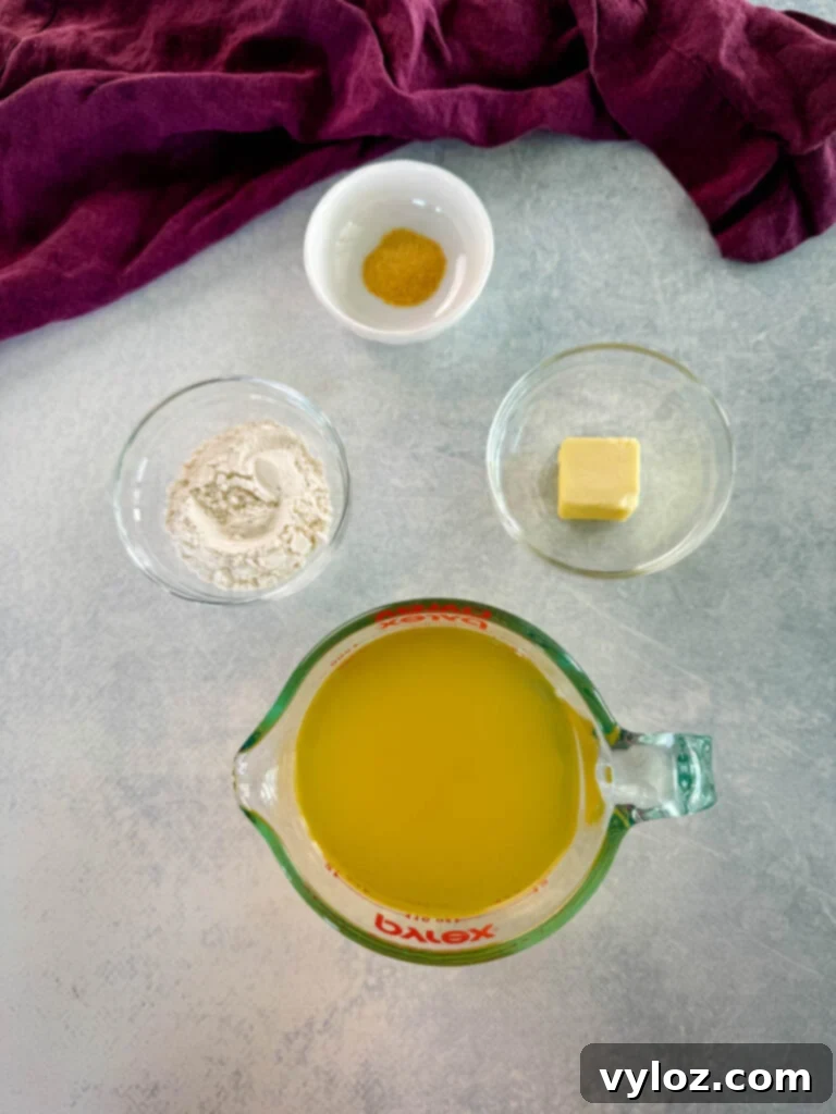Spices, flour, butter, and broth in separate glass bowls, ready for gravy making