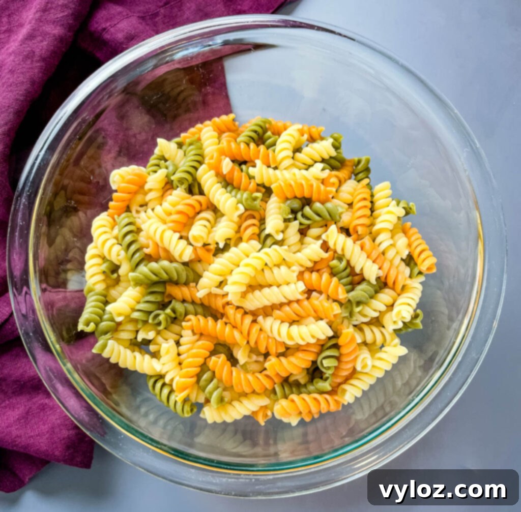Dry rotini pasta in a clear glass bowl