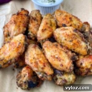 Crispy ranch chicken wings on a plate with ranch dressing