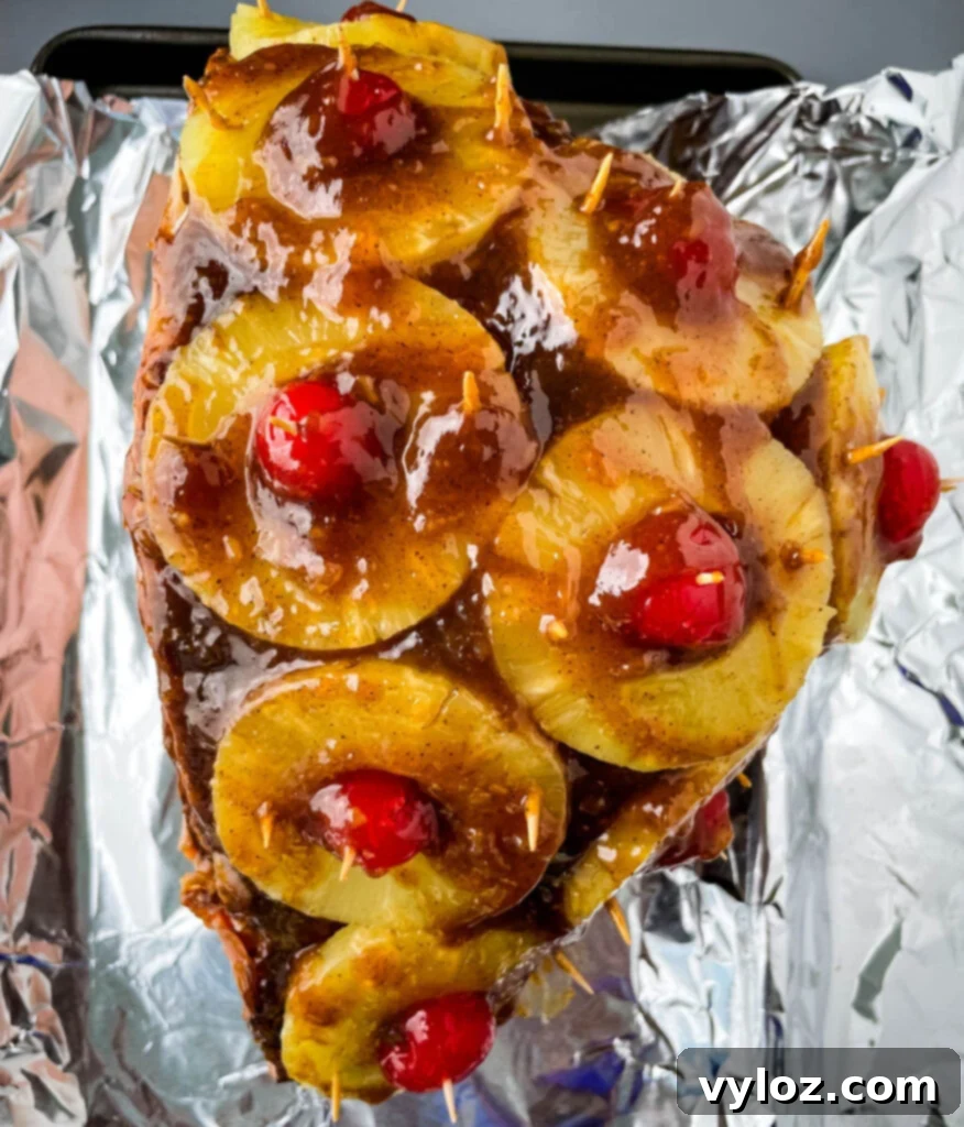 Golden Brown Sugar Pineapple Ham 9 Another perspective of the pineapple glazed ham on a sheet pan, highlighting the intricate arrangement of fruit and the rich glaze.