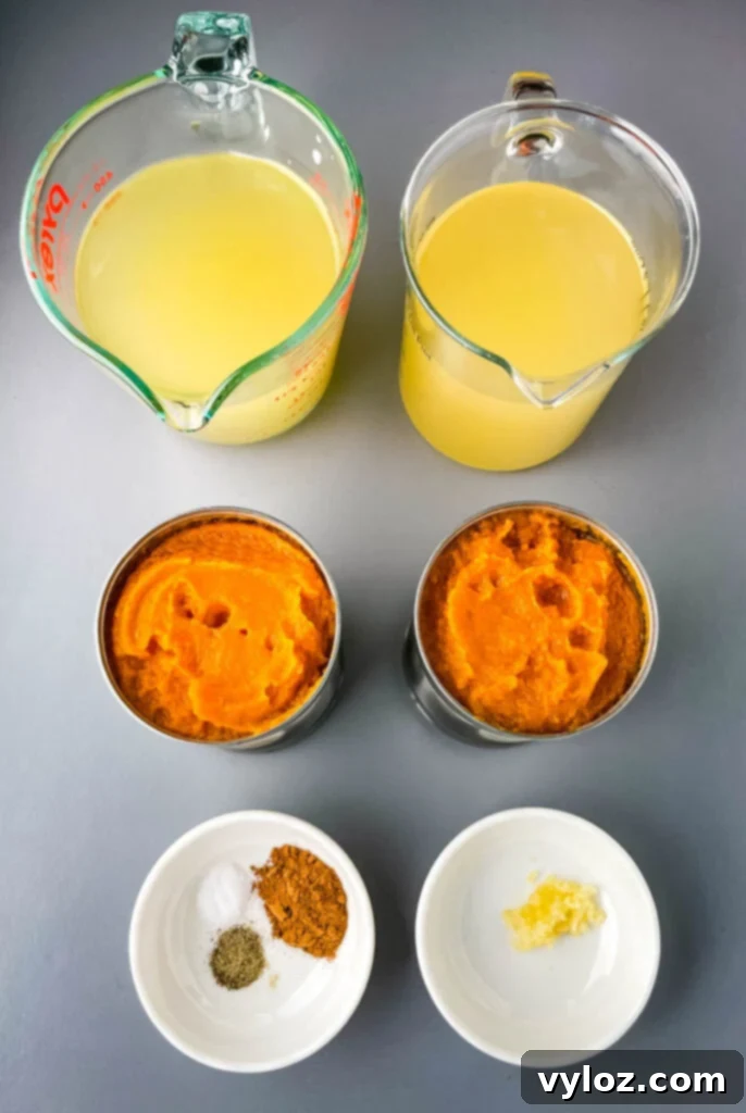 Quick Creamy Pumpkin Soup with Canned Pumpkin 3 broth, canned pumpkin, pumpkin pie spice, and garlic displayed in separate bowls
