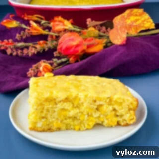 Homemade cornbread casserole, a comforting and easy Southern dish, presented on a white plate.