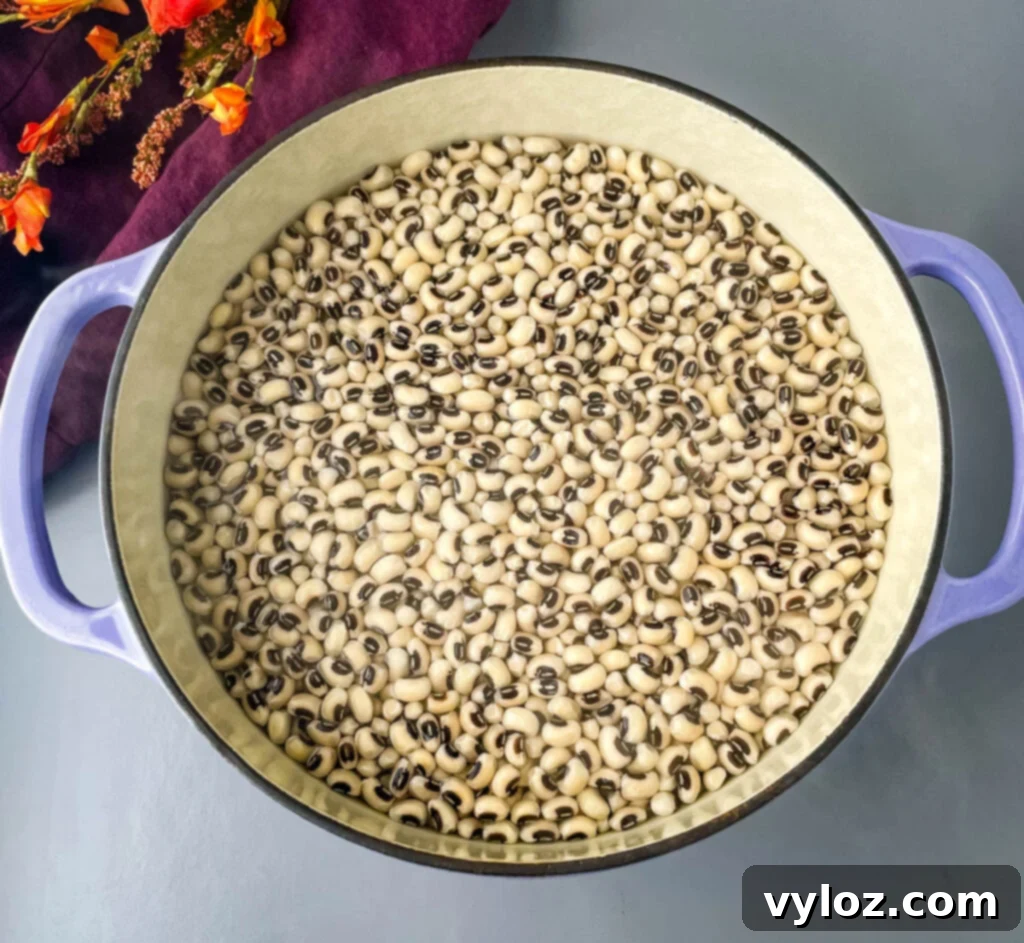 Classic Southern Black Eyed Peas and Smoked Turkey 4 Dried black eyed peas soaking in a bowl of hot water, a crucial step for reducing cooking time and improving texture.