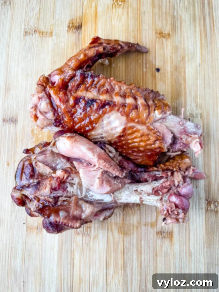 Classic Southern Black Eyed Peas and Smoked Turkey 6 A smoked turkey leg resting on a bamboo cutting board, ready to be shredded and added to the black eyed peas.